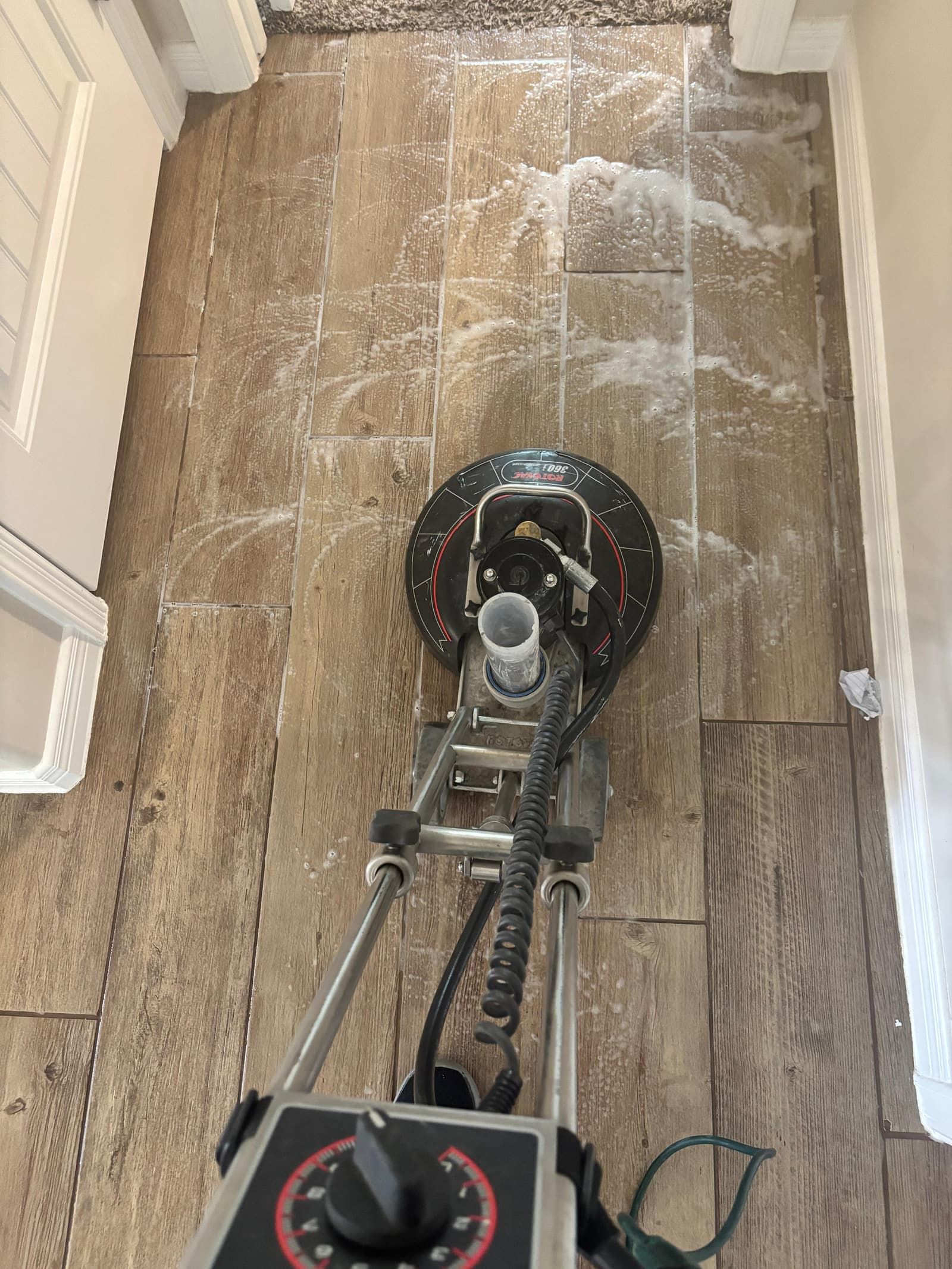 Rotary floor machine cleaning a hard floor in Las Cruces, NM