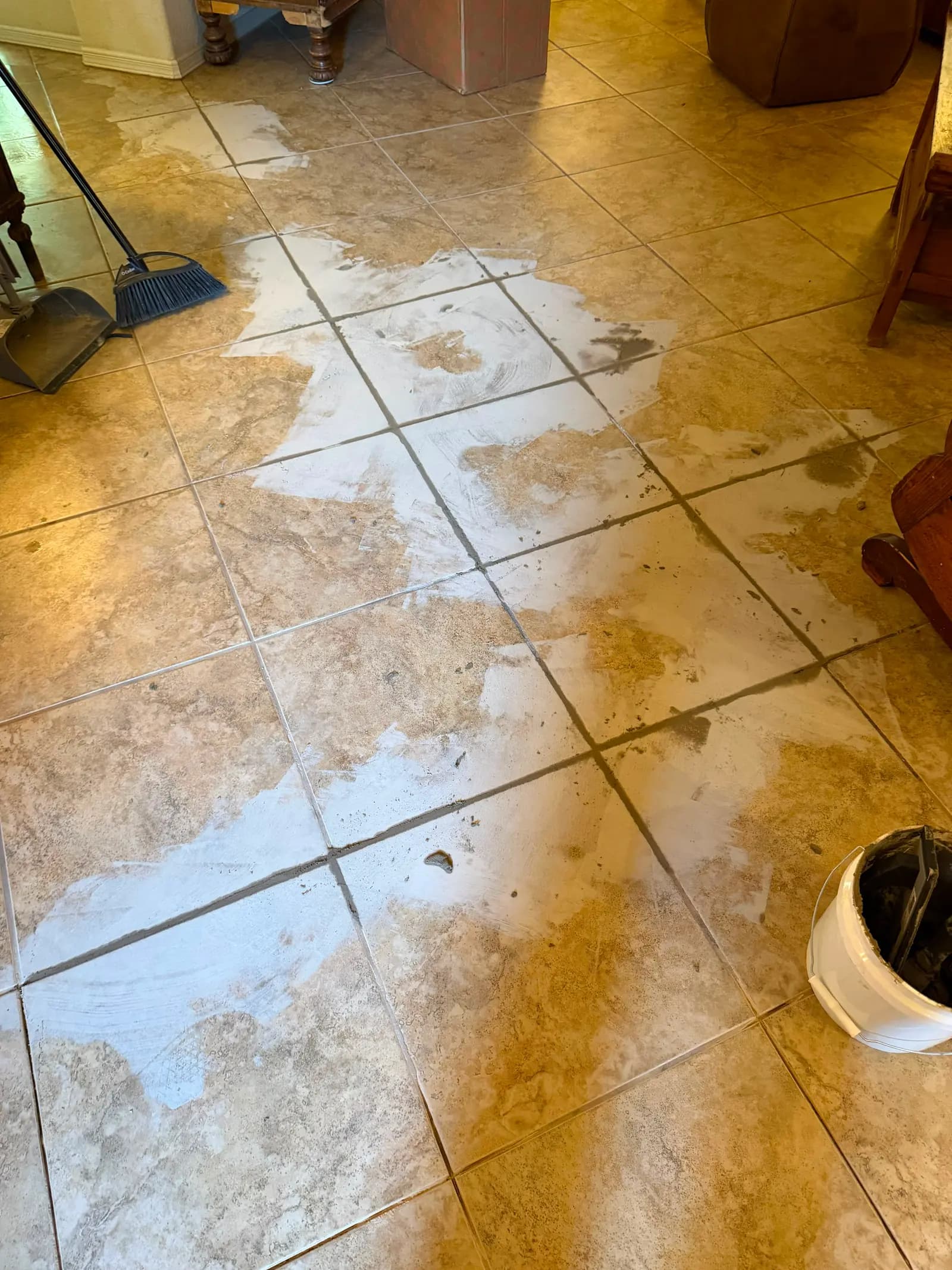 Tile and grout repair in progress with fresh grout floated into the joints of a Las Cruces, NM floor